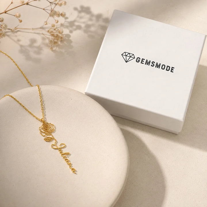 Gold birth flower name necklace displayed with Gemsmode gift box