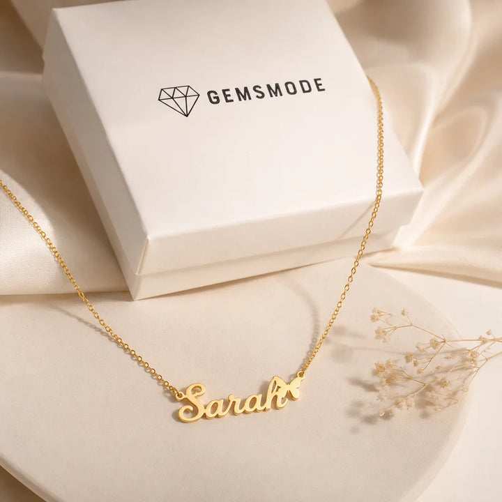 Gold personalized butterfly name necklace displayed with Gemsmode gift box