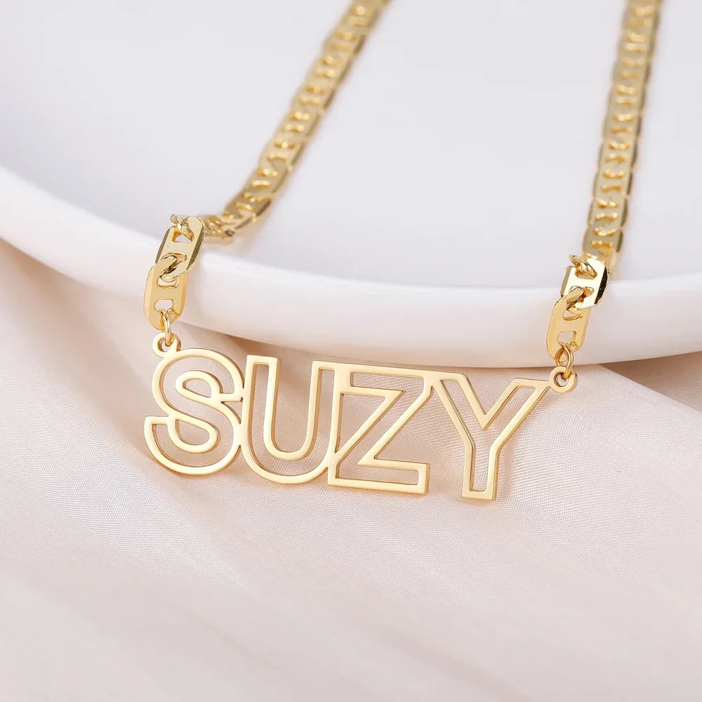 Gold Custom Cutout Block Name Necklace for Women Displayed on a Tray