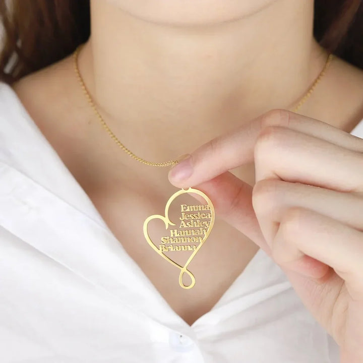 Model holding Custom Multiple Name Heart Necklace in gold.