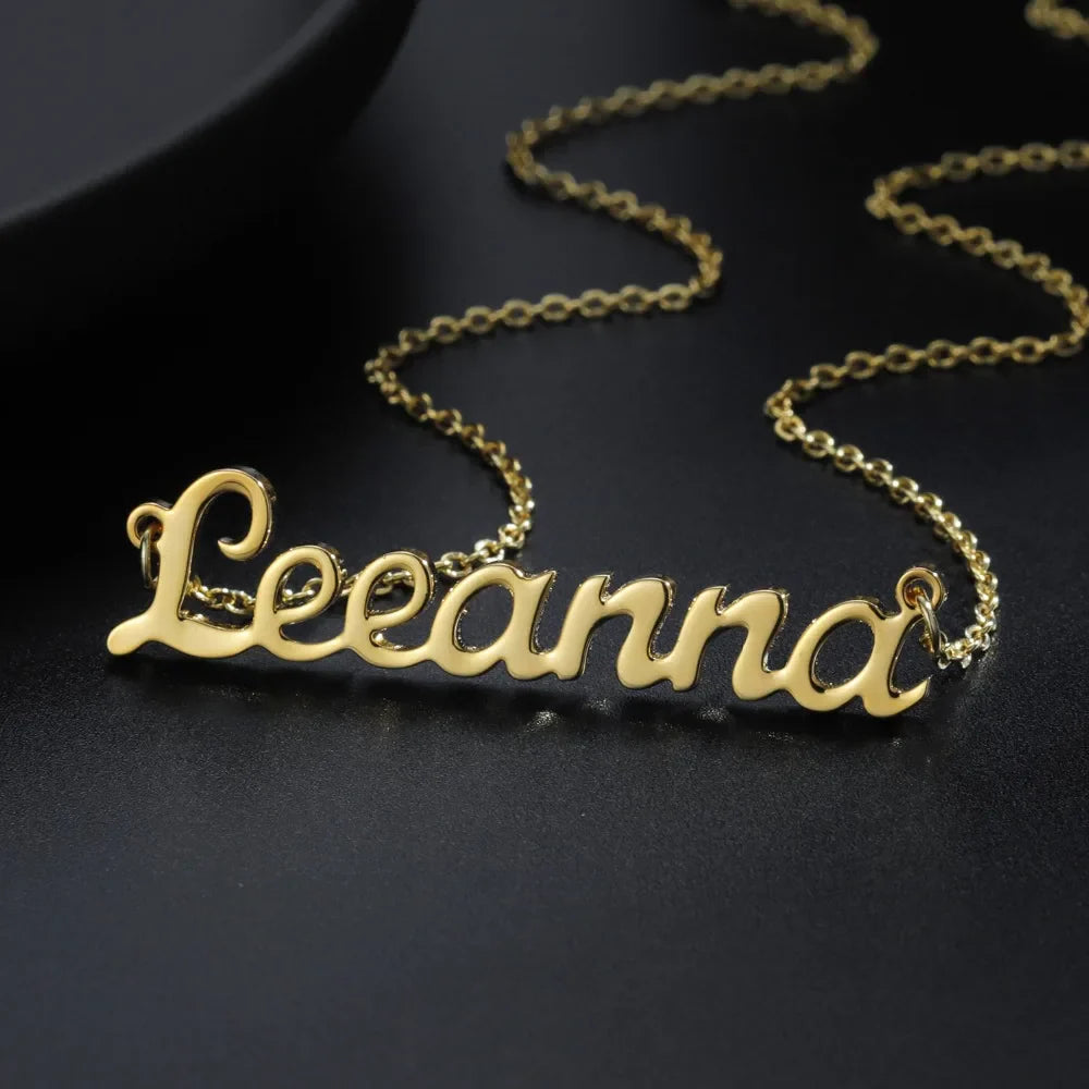 Gold custom name necklace with "Leeanna" inscription.