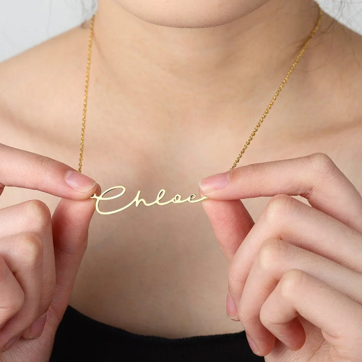 Custom signature name necklace in gold, worn by model