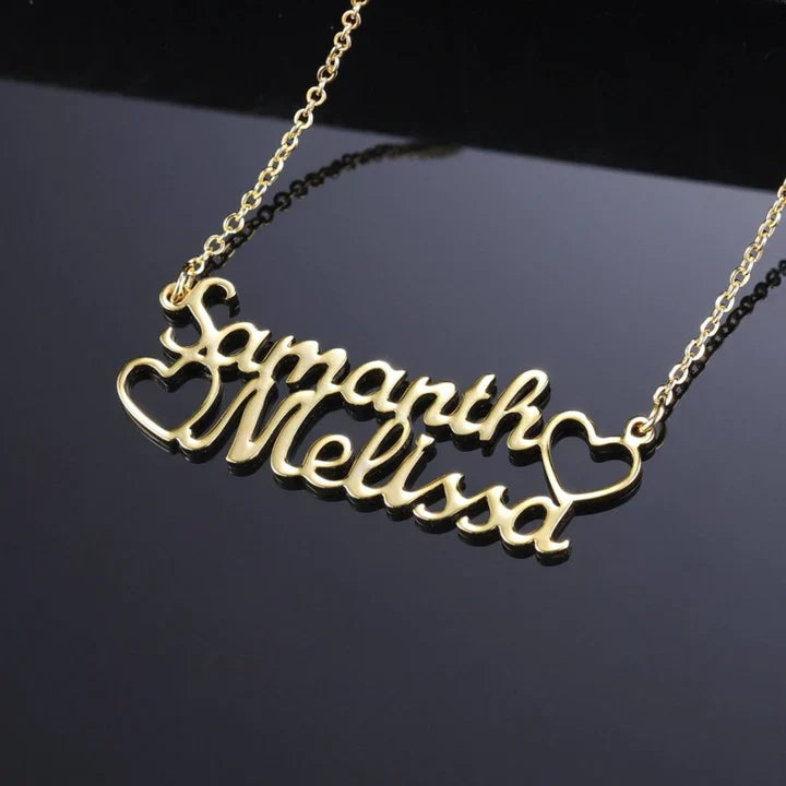 Close-up of double name heart necklace in gold