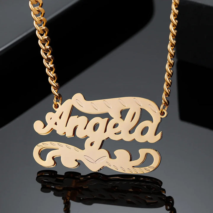 Double Plated 3D Name Necklace in gold with the name 'Angela' on a black background, second angled view.