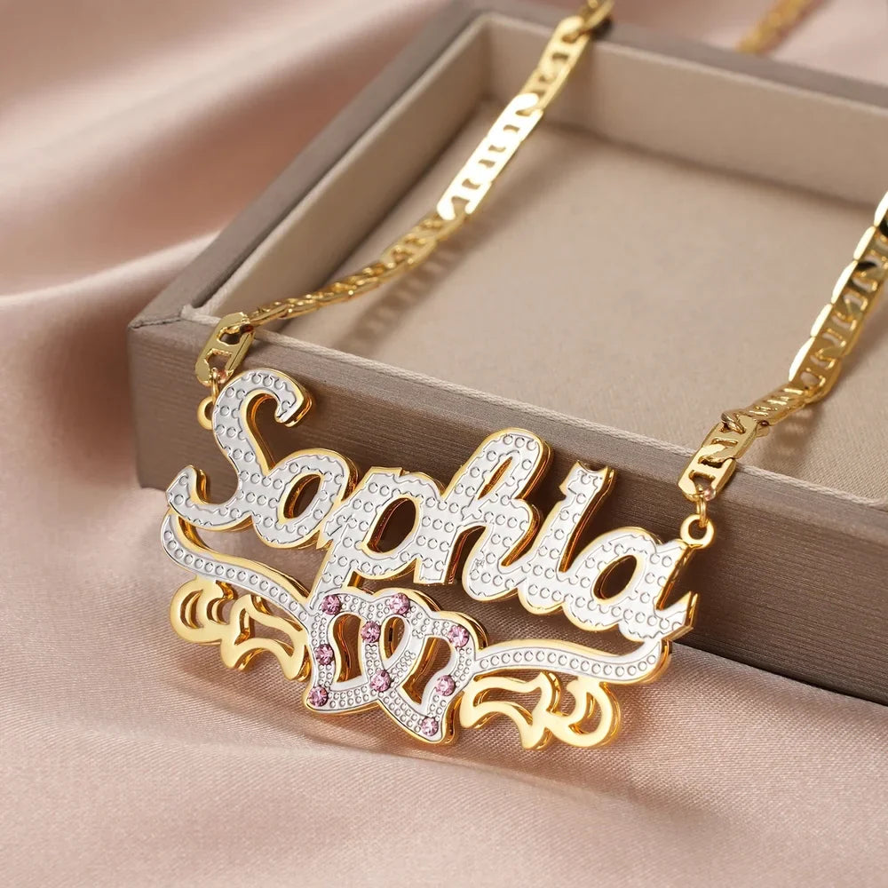 Close-up of double plated intertwined hearts name necklace in a box.