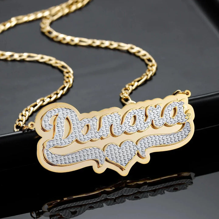 Close-up of double plated layered name necklace in gold