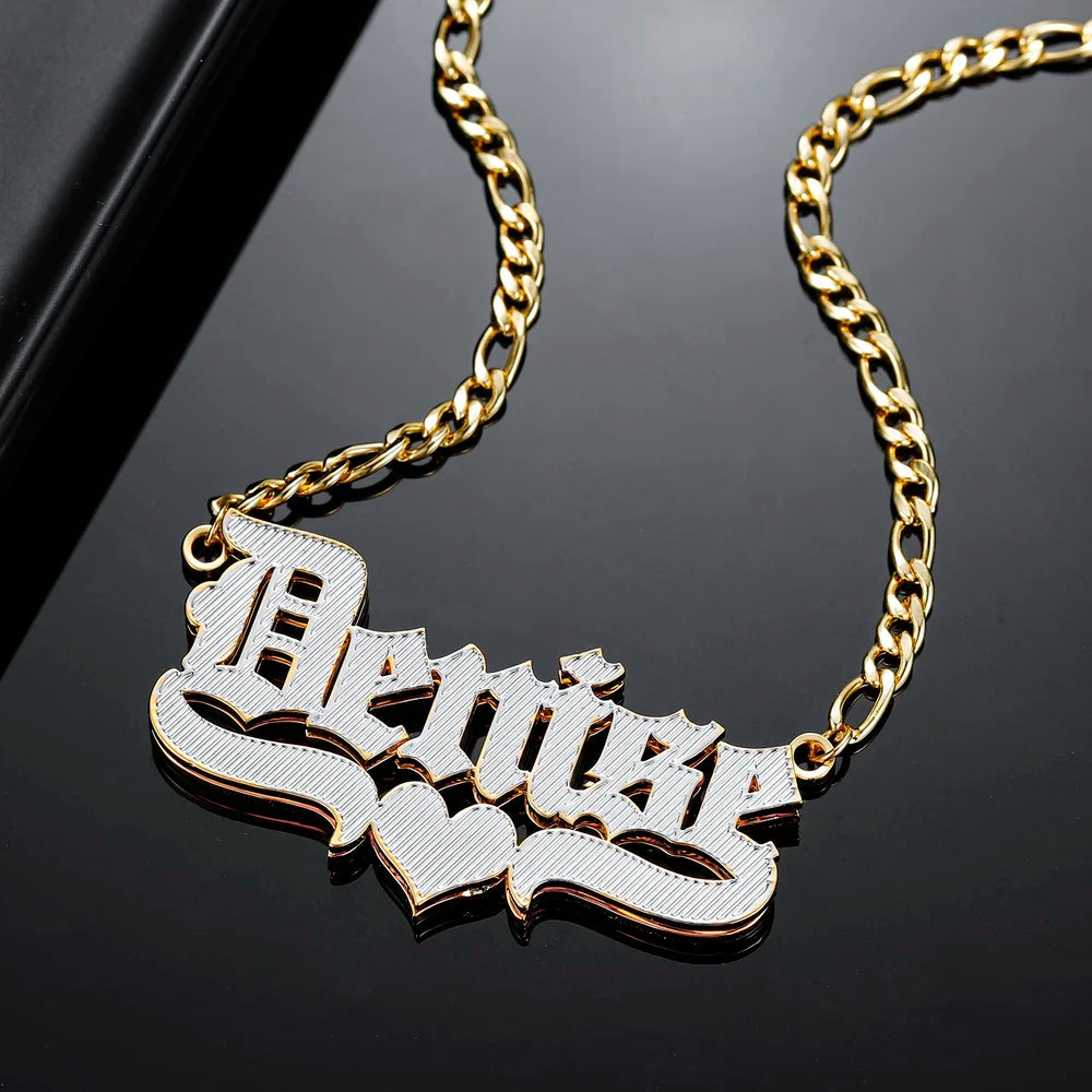 Close-up of Double Plated Old English Name Necklace in Gold with Figaro Chain