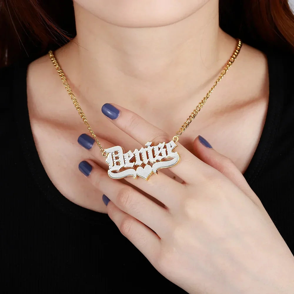 Double Plated Old English Name Necklace worn by model, holding the pendant