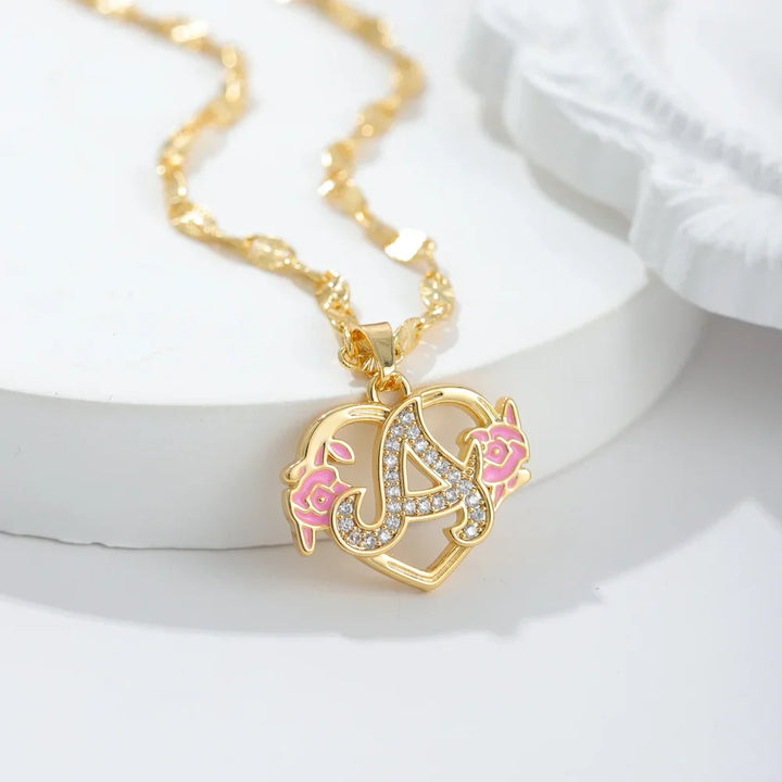 Closeup of Floral Iced Initial Necklace in Gold with Pink Floral Design