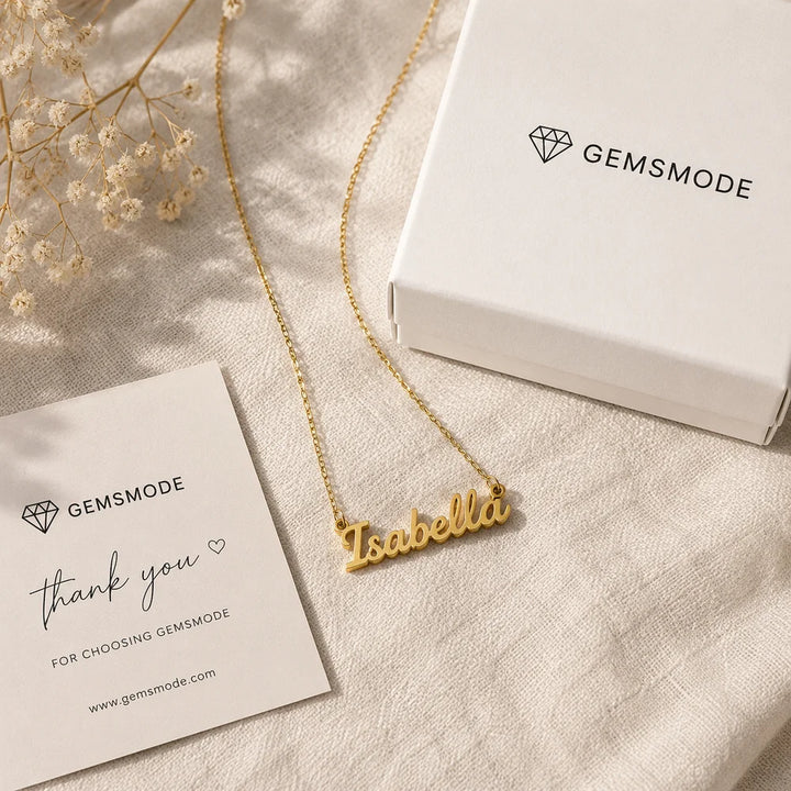 Gold-plated cursive nameplate necklace customized with the name Isabella, displayed with Gemsmode gift box packaging
