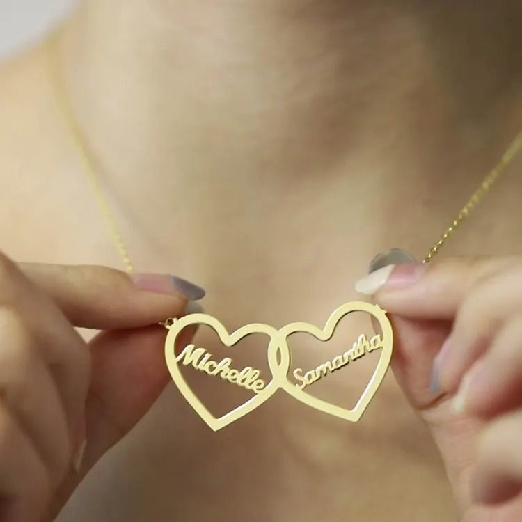 Closeup of gold twin hearts name necklace