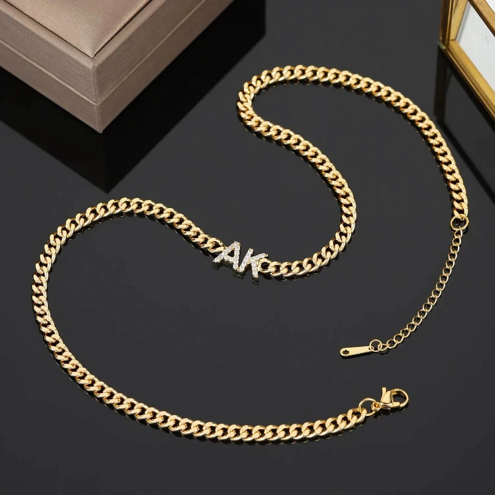 Full length view of iced initials necklace with cuban chain in gold