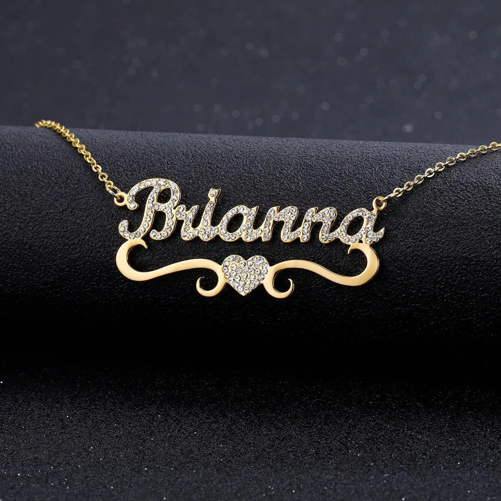 Gold Iced Out Heart Name Necklace personalized with the name Brianna, displayed on a black background.