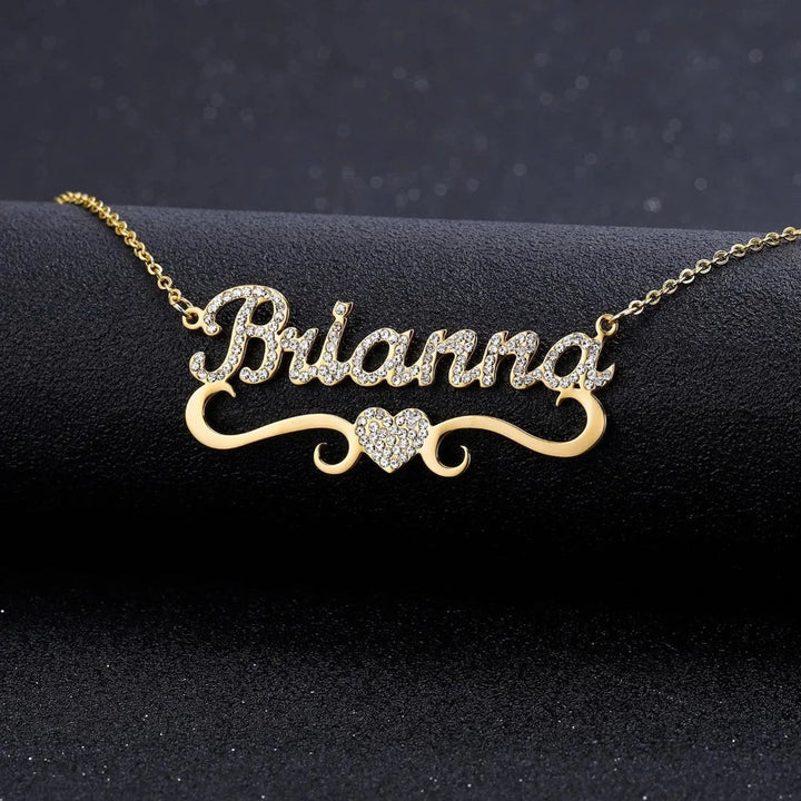 Gold Iced Out Heart Name Necklace personalized with the name Brianna, displayed on a black background.