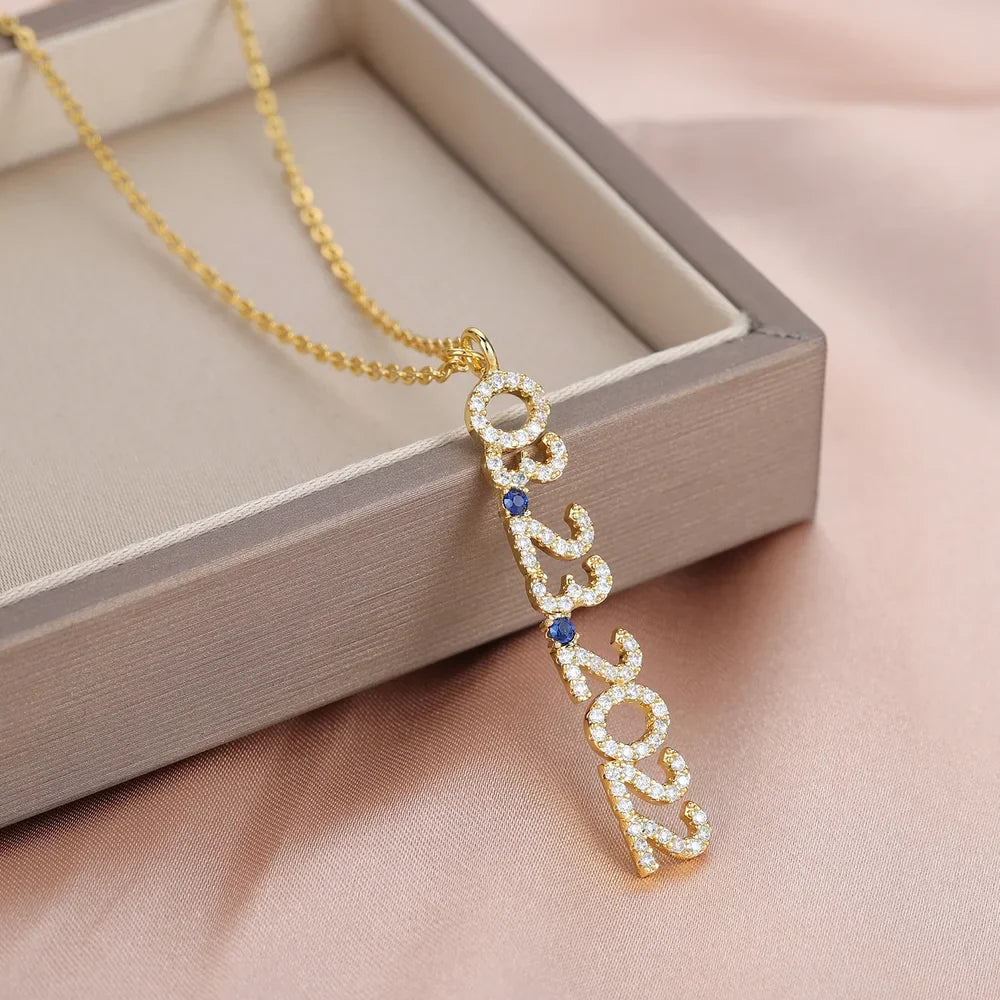 Gold Iced Vertical Date Necklace with link chain displayed in a jewelry box