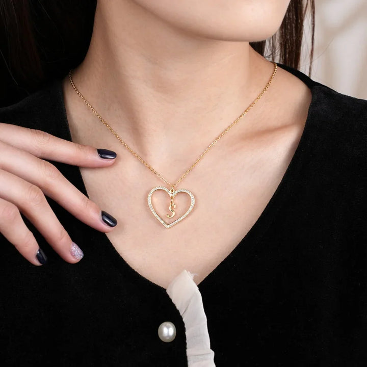 Woman Wearing Gold Initial Heart Necklace