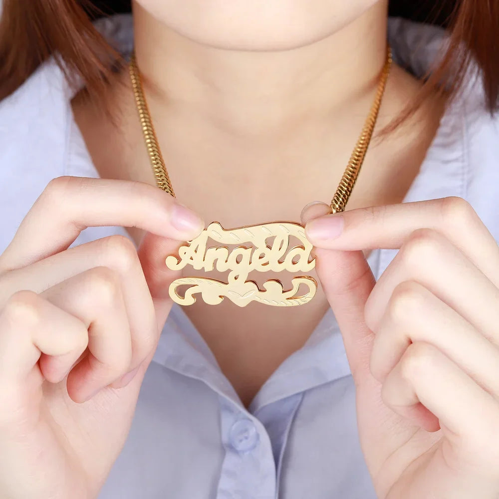 Model holding a gold Double Plated 3D Name Necklace with the name 'Angela'