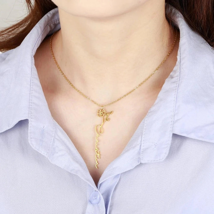 Model wearing a gold Personalized Birth Flower Name Necklace with the name 'Christina', featuring a delicate floral motif.