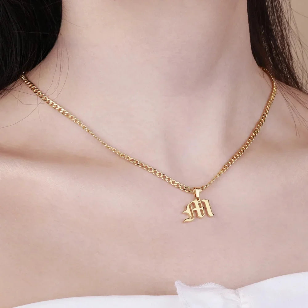 Model wearing Old English Initial Necklace with Cuban Chain in Gold - Letter M