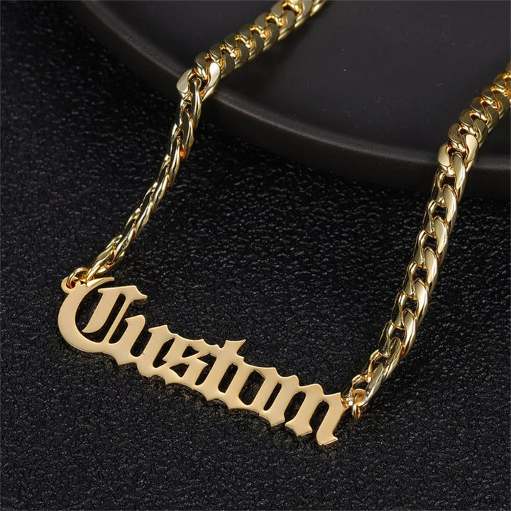 Close-up of Old English name necklace with Cuban chain in gold