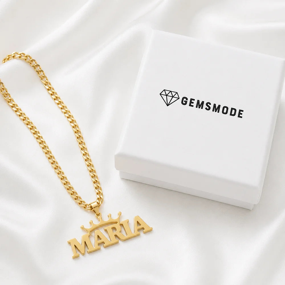 Personalized crown name necklace in gold with custom name "Maria" displayed on satin fabric beside a gemsmode gift box