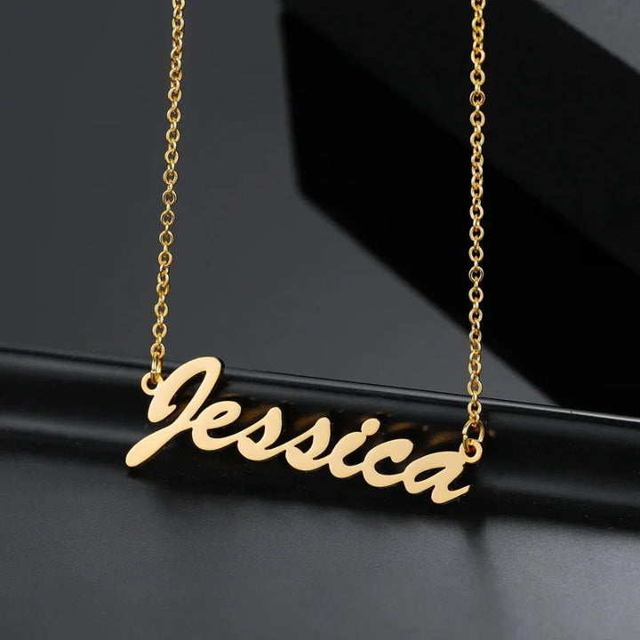 Close-up view of the gold personalized cursive name necklace.