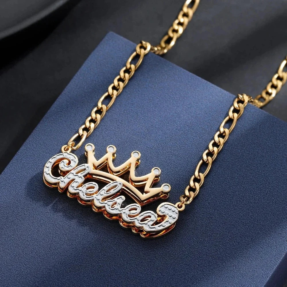 Elegant gold personalized double plated crown name necklace on a dark background