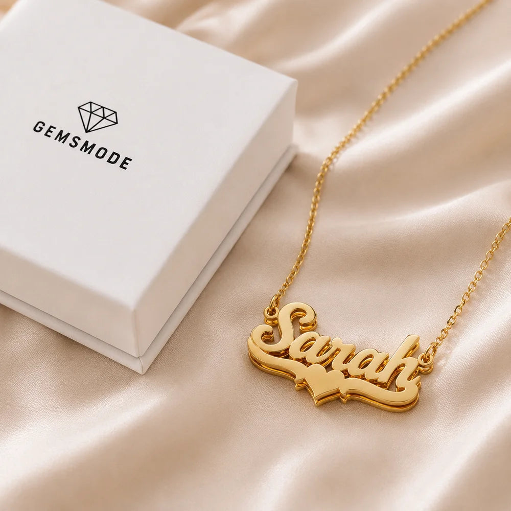 Personalized gold heart name necklace with Sarah name beside Gemsmode jewelry box