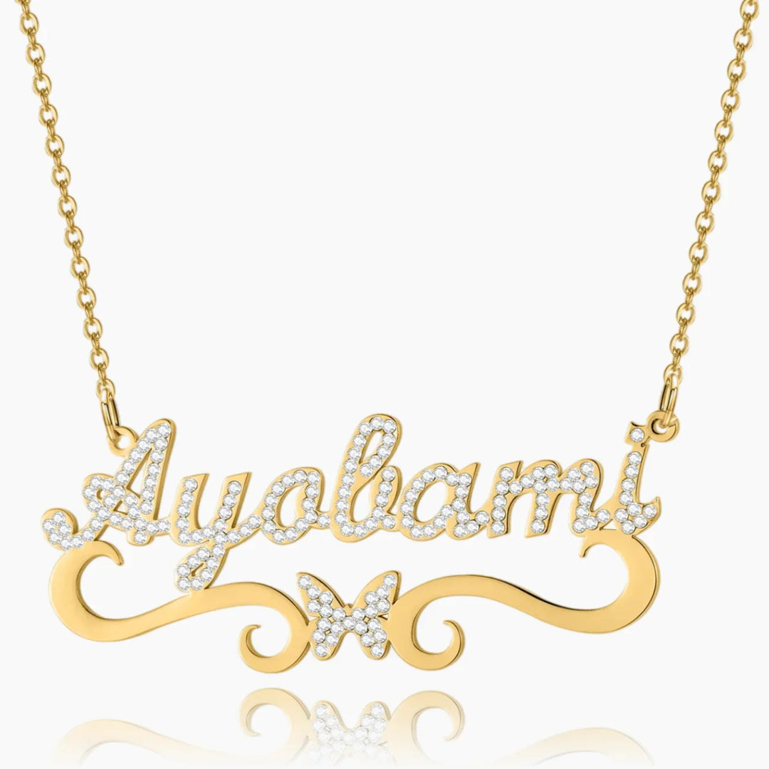 Front view of personalized iced butterfly name necklace in gold 