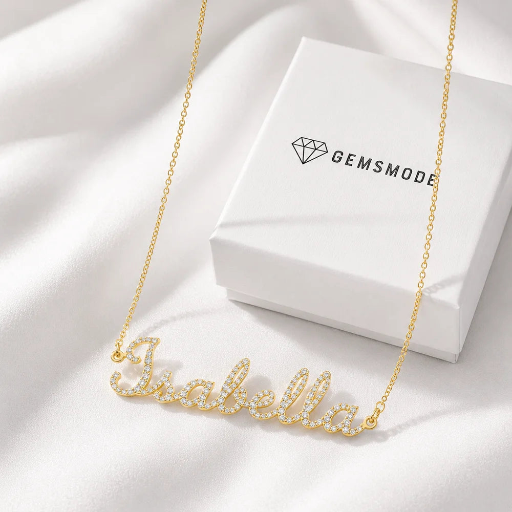 Personalized Iced Name Necklace with "Isabella" in gold, shown with Gemsmode jewelry box.