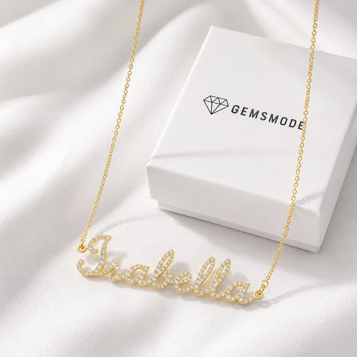 Personalized Iced Name Necklace with "Isabella" in gold, shown with Gemsmode jewelry box.
