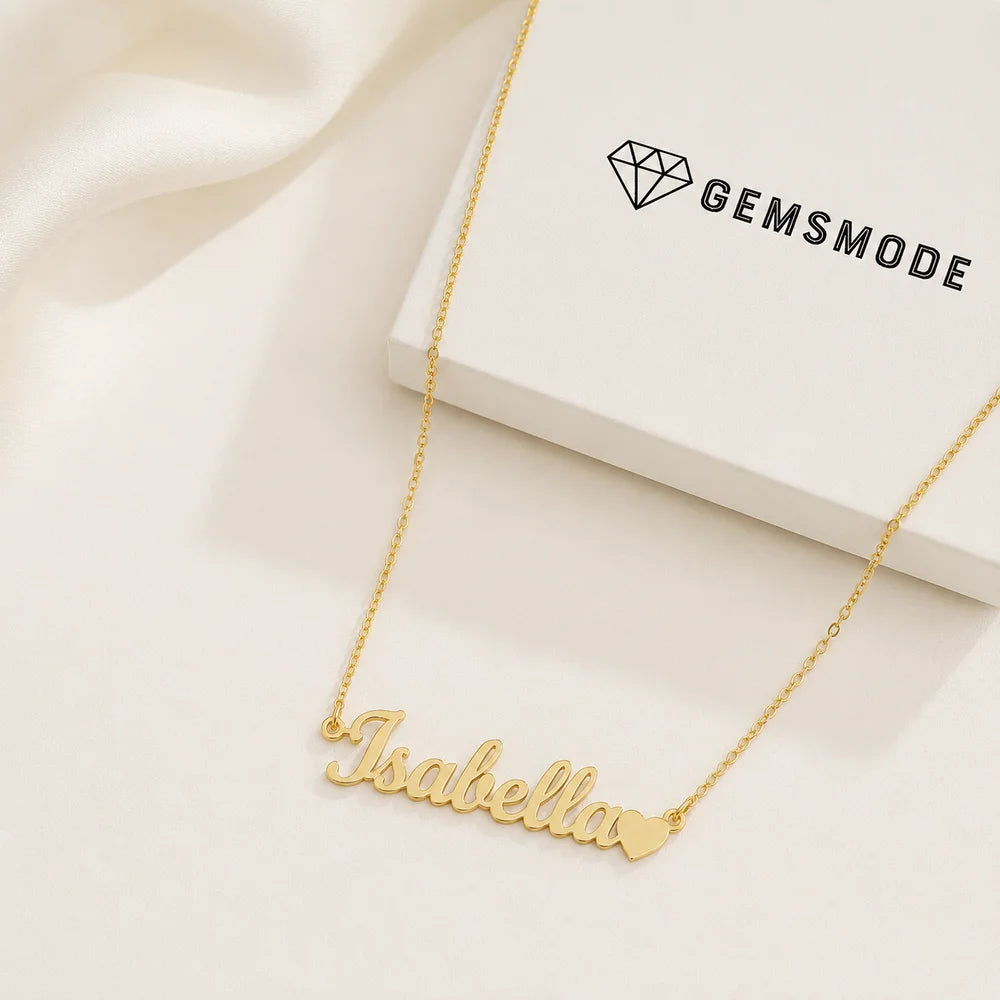 Personalized name necklace with heart charm in gold with custom name "Isabella" displayed beside a gemsmode gift box