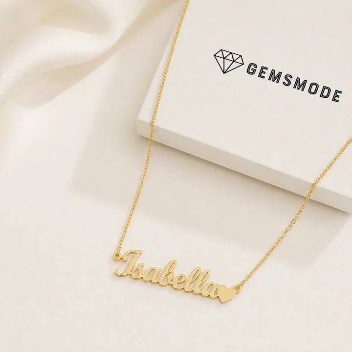 Personalized name necklace with heart charm in gold with custom name "Isabella" displayed beside a gemsmode gift box